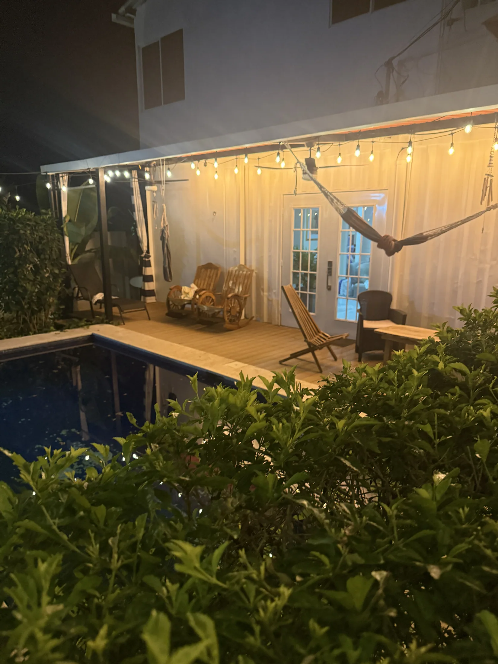 Pool and covered patio at night